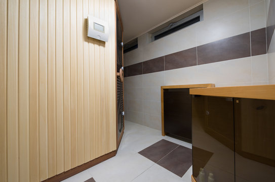 Modern Finnish style sauna cabin in bathroom