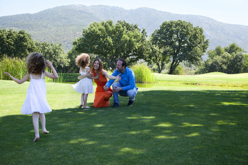 Happy family is enjoying at park on a weekend day