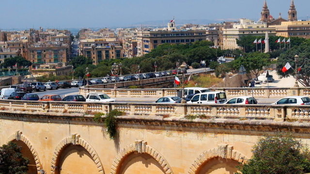 VALLETTA, MALTA - JULY 23, 2015: View on Triq Cirolamo Cassar aduct road from Upper Barrakka Gardens in Valetta, Malta
