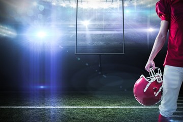 Composite image of an american football player taking his helmet