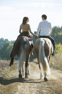 Young Couple In Love Riding A Horse