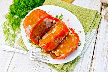 Pepper stuffed meat with sauce in plate on table