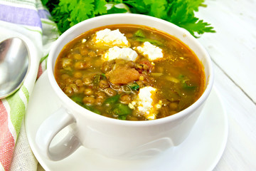 Soup lentil with spinach and feta on light board