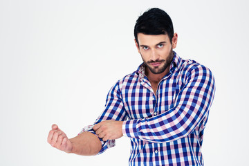Fototapeta premium Portrait of a handsome man rolls up his sleeves
