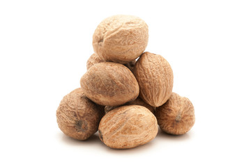 Pile of Organic Nutmeg Seed or Jaiphal (Myristica fragrans) isolated on white background.