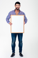 Happy man holding blank board