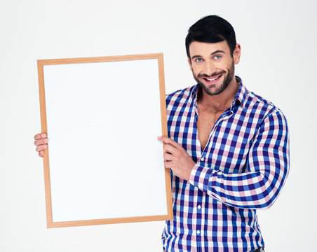 Smiling handsome man holding blank board