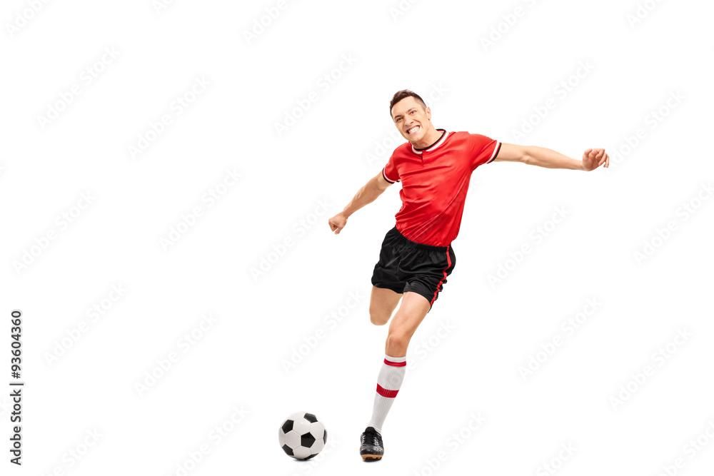 Poster Young football player kicking a ball