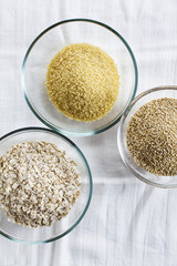 Cereals in bowls : Oats, Couscous, Quinoa