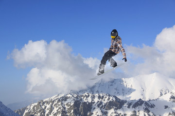 Flying snowboarder on mountains