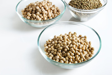 Soybeans in bowl and other Legumes on white