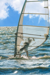 Windsurfing on the background of blue sea