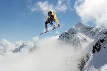 Flying snowboarder on mountains