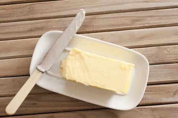 Foto op Plexiglas Pat of fresh farm butter on a dish © Stephen Gibson