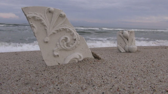 Ornamental and floral broken plaster casts by the sea