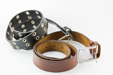 Old two leather belt roll on white background.