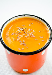Vegetarian carrot-pumpkin cream soup with flax seeds