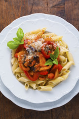 Pasta with roasted sweet Peppers and Eggplant on wooden vintage