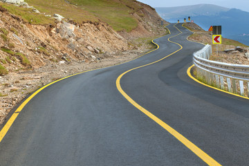 Driving on winding asphalt road on mountain