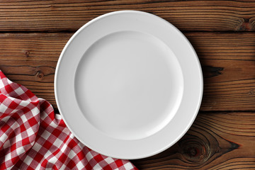white dish on wooden table - obrazy, fototapety, plakaty