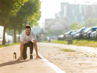 Portrait of smiling man resting after workout outdoors, fit caucasian