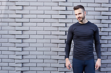 Portrait of smiling man resting after workout outdoors, fit caucasian