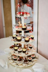 Delicious cupcakes on table on light background