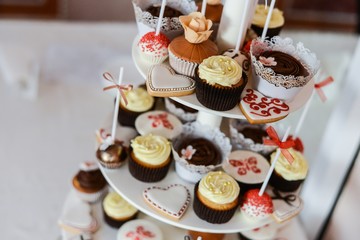 Delicious cupcakes on table on light background