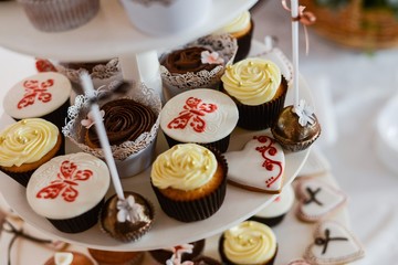 Delicious cupcakes on table on light background