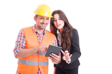 Smiling modern builder and business woman using wireless tablet