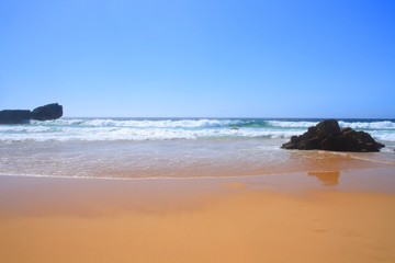 Beautiful sandy beach with big waves in Atlantic ocean