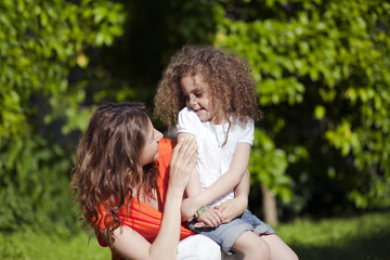 Fototapeta premium Mother and daughter are enjoying on grass at park
