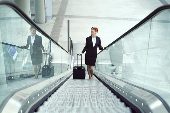 Hostess on escalator in airport