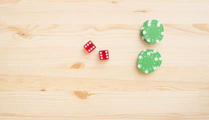 Casino dice and chips on wooden background