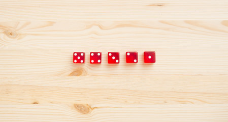 Red casino dice on wooden background