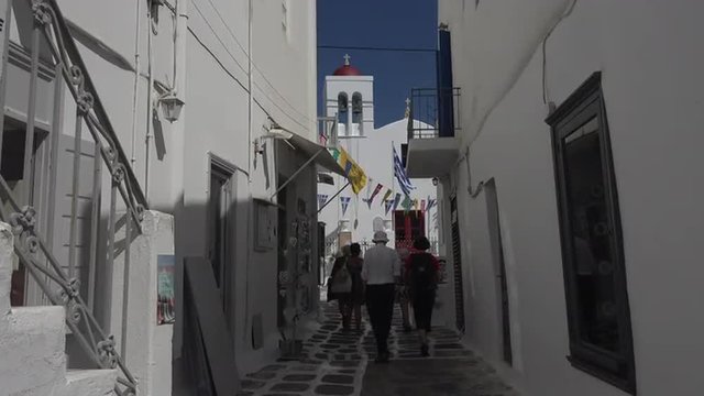 Mykonos Greece tourists white washed street alley 4K 129