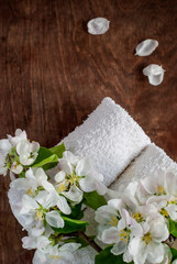 Fototapeta na wymiar Apple Tree Flowers and White Towel on wooden background