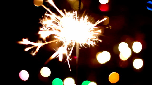 Fireworks with defocussed Christmas tree in the background. 