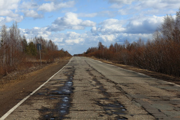 Autumn road and sky with clouds