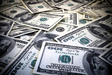 Mount of hundred dollar banknotes background texture high contrasted with vignetting effect