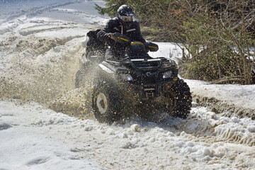 man driving a quad bike in the winter field © brszattila