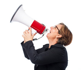 portrait of a mature business woman shouting with a megaphone