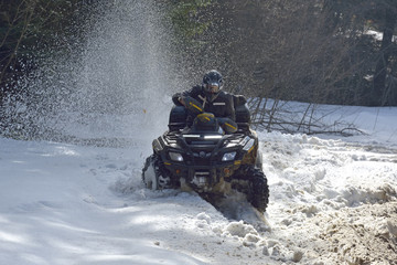 man driving a quad bike in the winter field © brszattila
