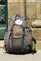 pilgrim rucksack with shell in Way of St James to Compostela cathedral