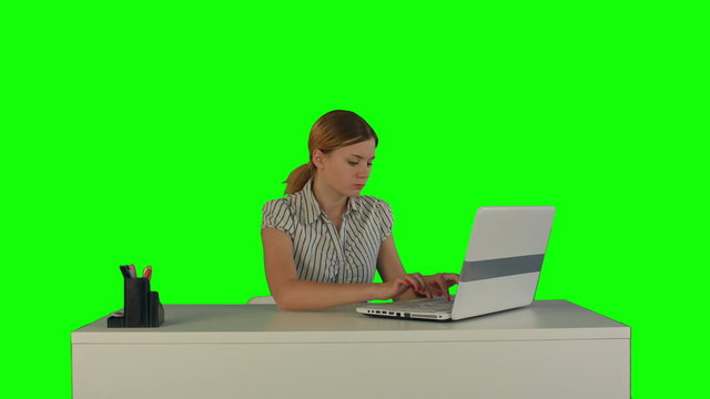 Businesswoman working on laptop on a Green Screen