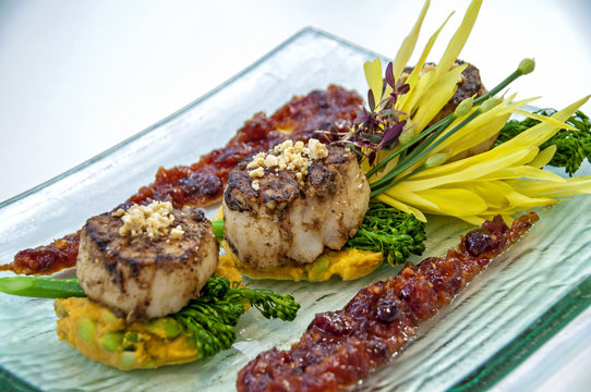 gourmet scallops with a broccolini, asparagus, sweet potato mashed potato, and a cranberry sauce