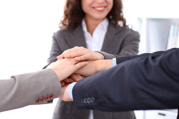 business people group joining hands and representing concept of friendship and teamwork