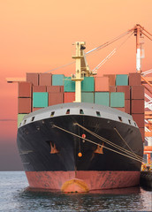 Cargo freight ship with stacked container at harbor terminal..