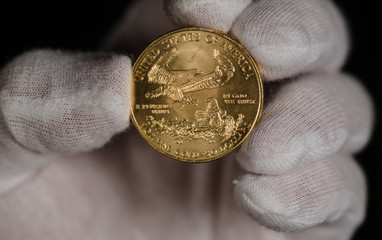 American Gold Eagle Being Held White Gloves