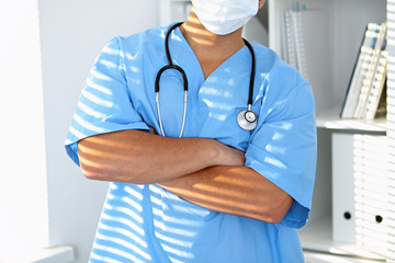 Portrait of unknown male surgeon doctor holding his stethoscope, crossed arms